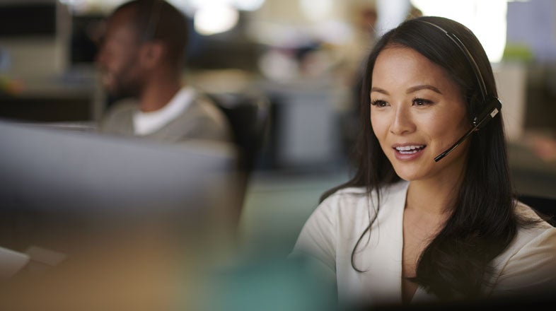 Customer service representative helping a customer over the computer