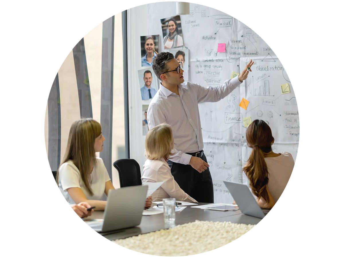 Group of colleagues collaborating in front of a bulletin board