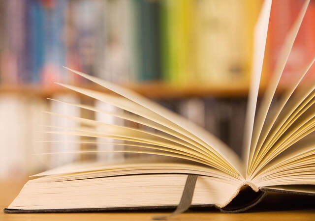 Book laying open on a table in a library