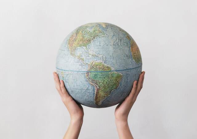 Person holding globe overhead