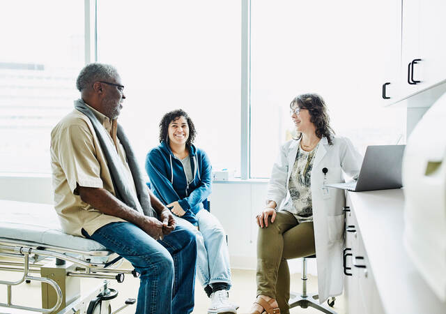 People sitting in a room with a doctor