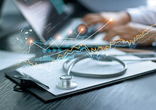 Charts and graphs superimposed over an a medical desk