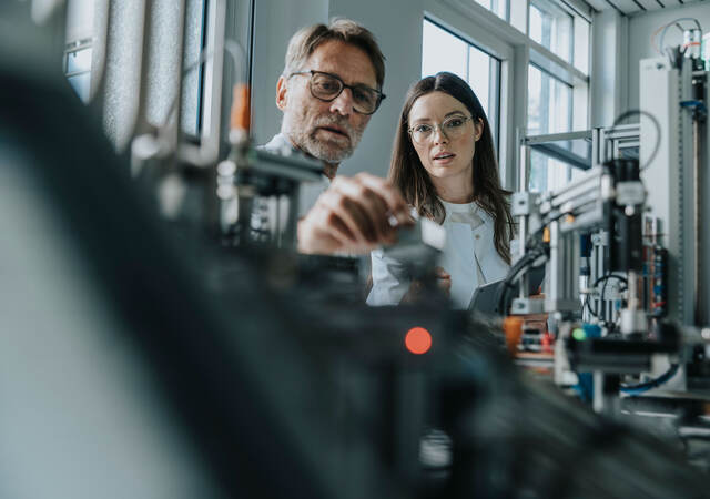 People in a lab testing components