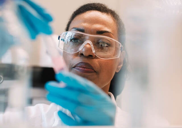 Lab technician filling a syringe