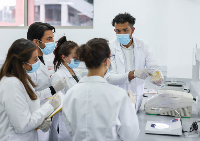 Group of lab technicians taking notes