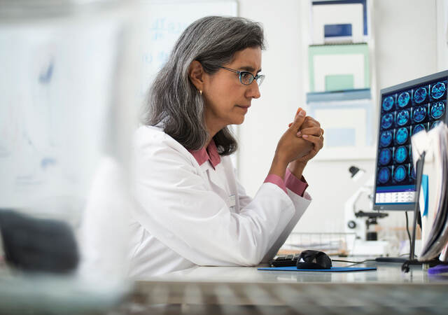 Doctor reviewing x-rays on a computer