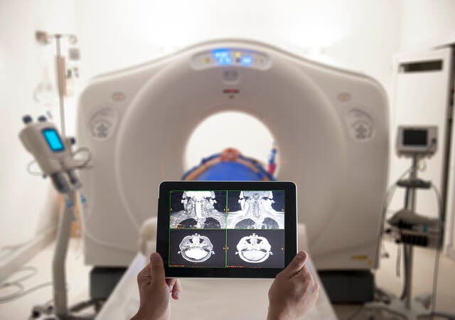 Doctor viewing MRI results on a tablet