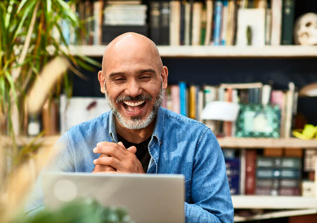 Person clasping hands and smiling