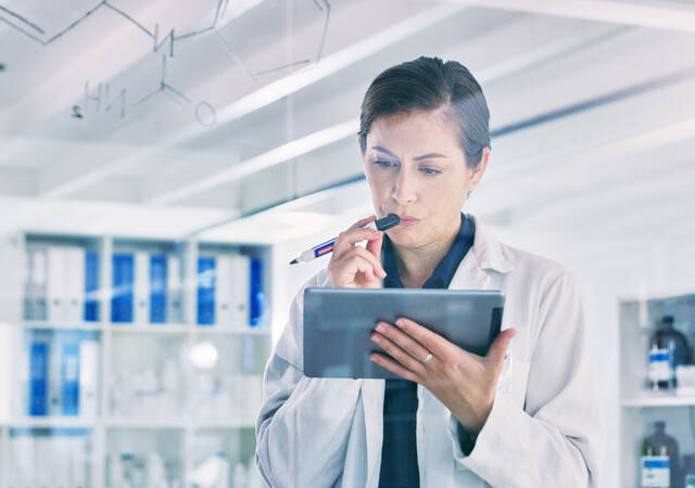 Scientist reviewing data on a tablet