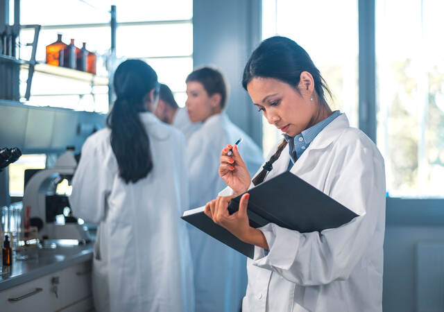 Medical doctor reviewing notes in a book