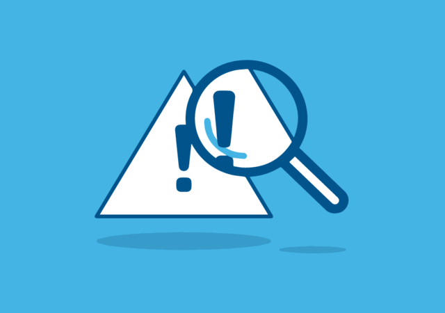 Magnifying glass looking at triangular warning icon