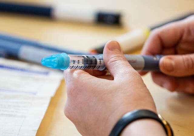 Person holding a syringe