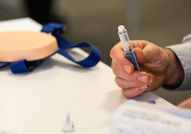 Person holding a syringe