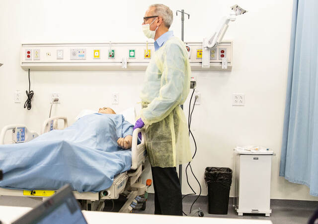 Doctor standing over patient in a hospital