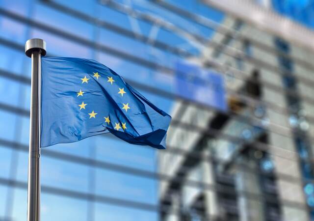 EU flag waving in front of a building