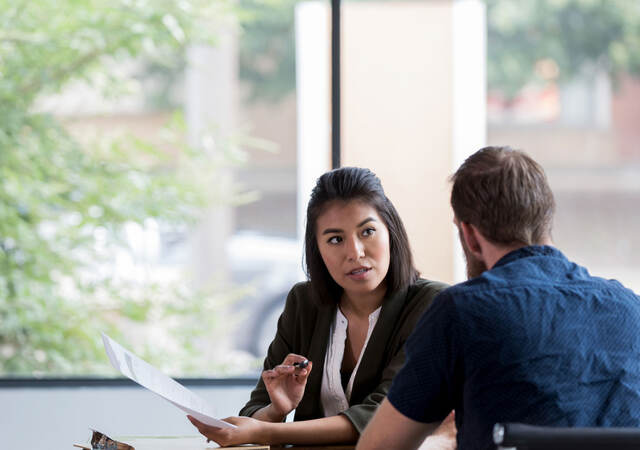 Two people discussing a document