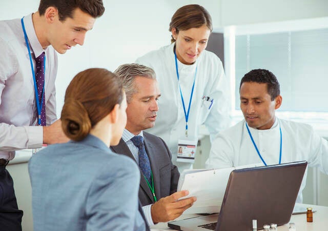 Scientists and business people talking in a conference room