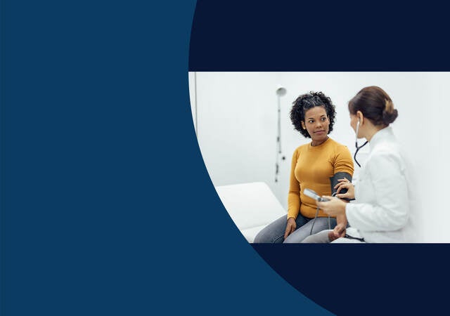 Doctor testing a patient's blood pressure