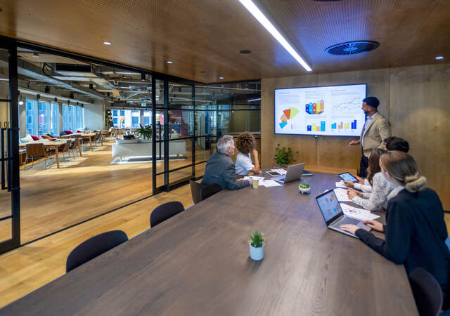 Group of colleagues having a meeting in a contemporary office setting