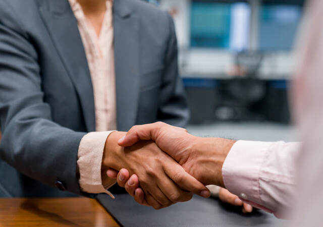 Close up of two business professionals shaking hands