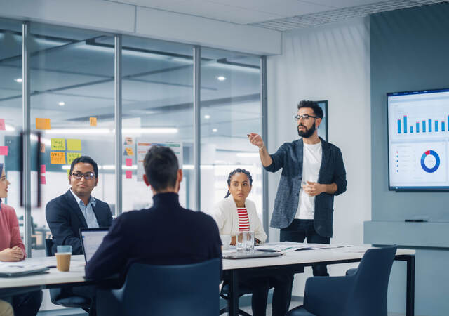 Meeting in a conference room to discuss metrics