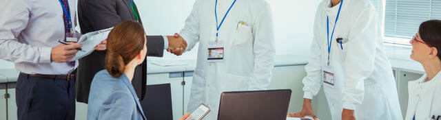 A meeting between business professionals and medical professionals