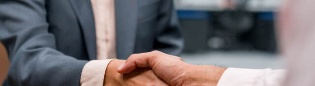 Close up of two business professionals shaking hands