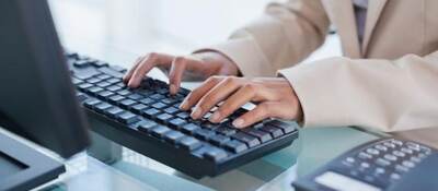 Hands typing on a keyboard.