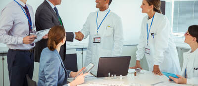 A meeting between business professionals and medical professionals