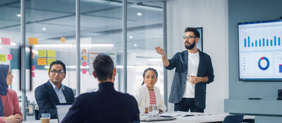 Meeting in a conference room to discuss metrics