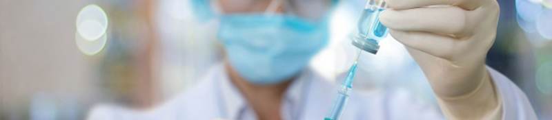 Nurse filling a syringe