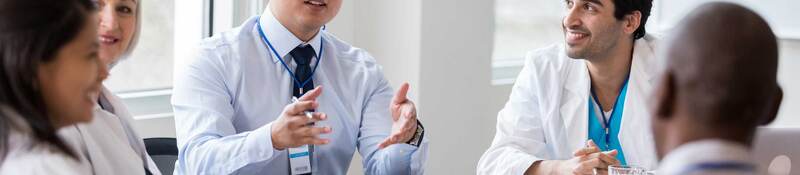 Group of medical professionals having a discussion around a table