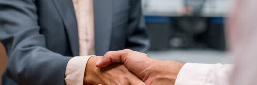 Close up of two business professionals shaking hands