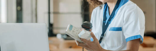 A technician scans the barcodes on medicine boxes