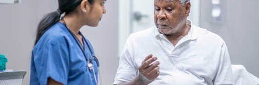 Nurse examining older patient