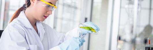 Scientist woman lab technical service observe liquid sample with lab glassware and test tubes in chemical laboratory