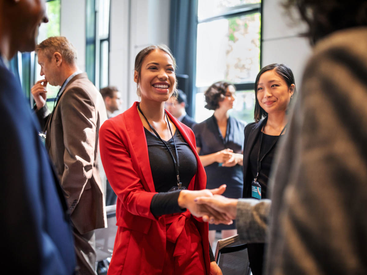 People shaking hands at a business event