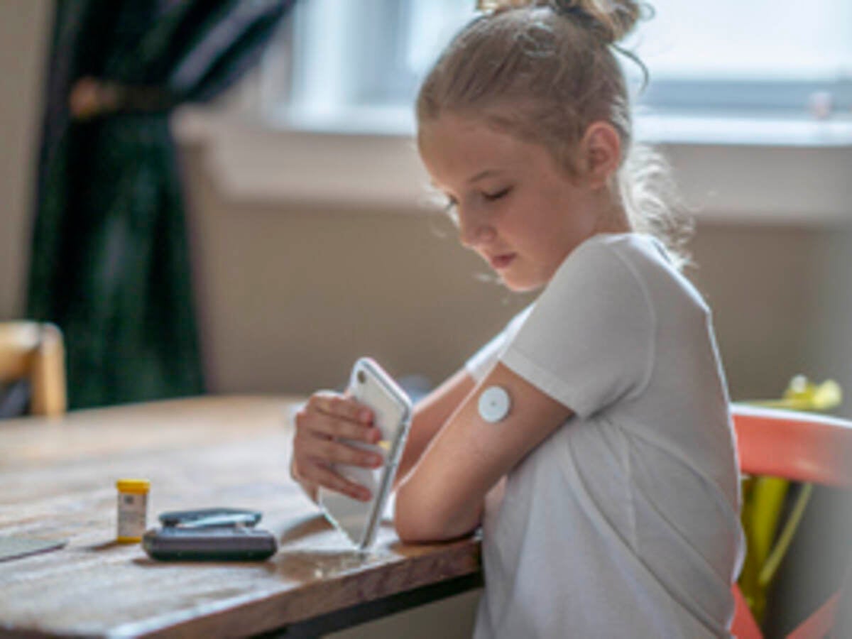 Girl using mobile phone as a medical device