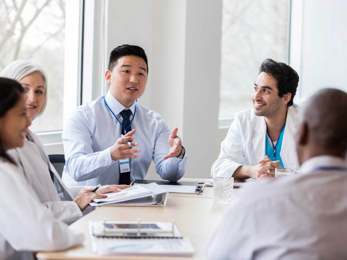 Group of medical professionals having a discussion around a table