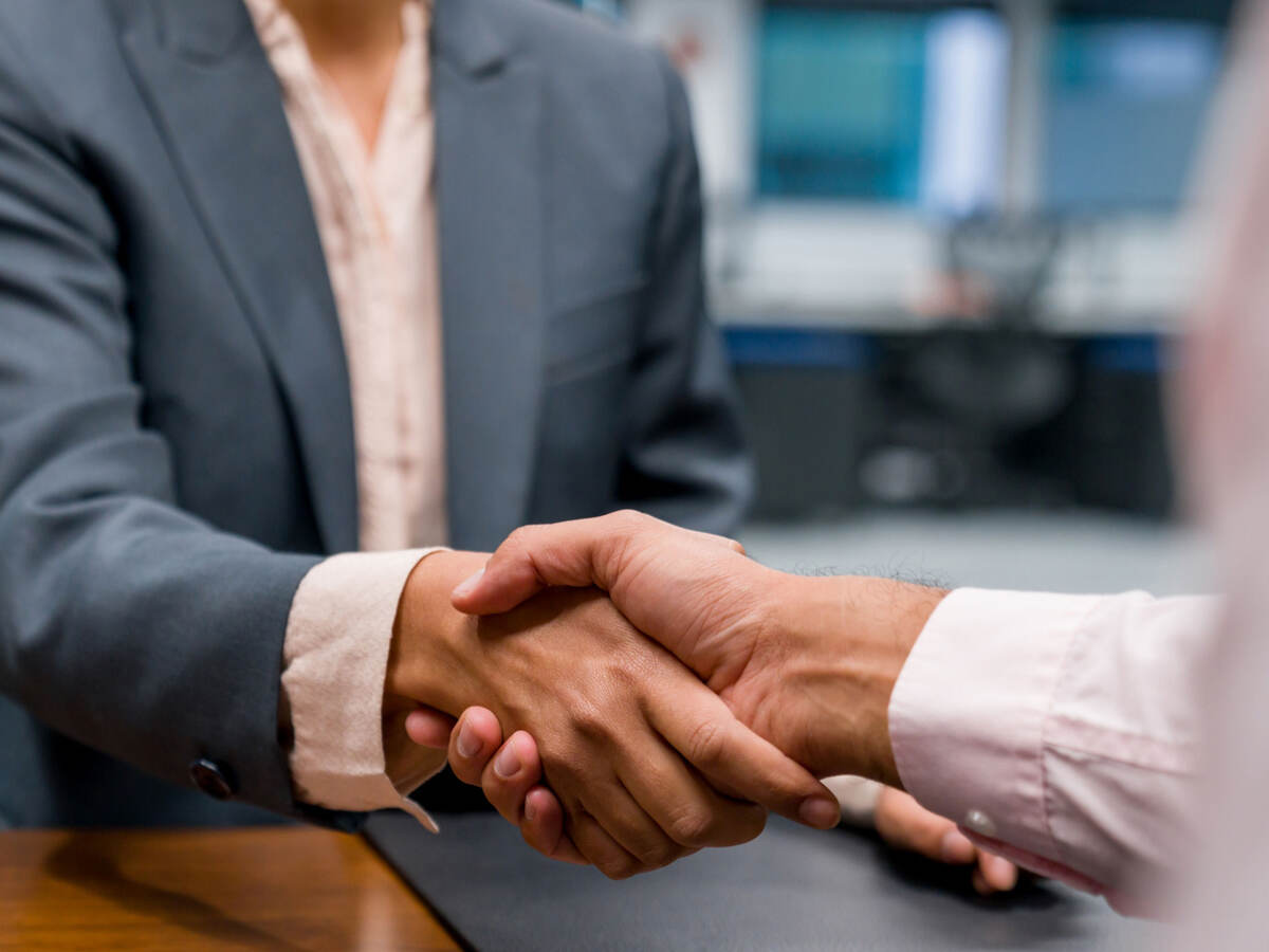 Close up of two business professionals shaking hands