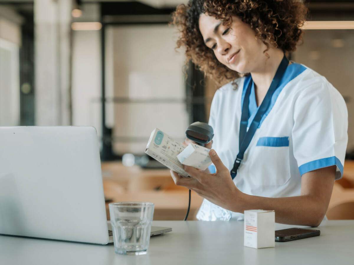 A technician scans the barcodes on medicine boxes