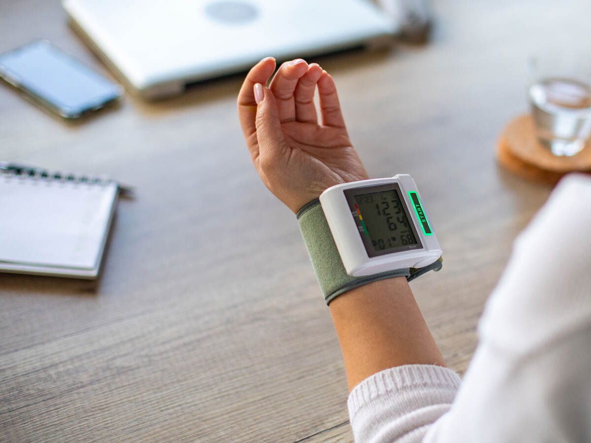 Closeup of a person wearing a blood pressure cuff