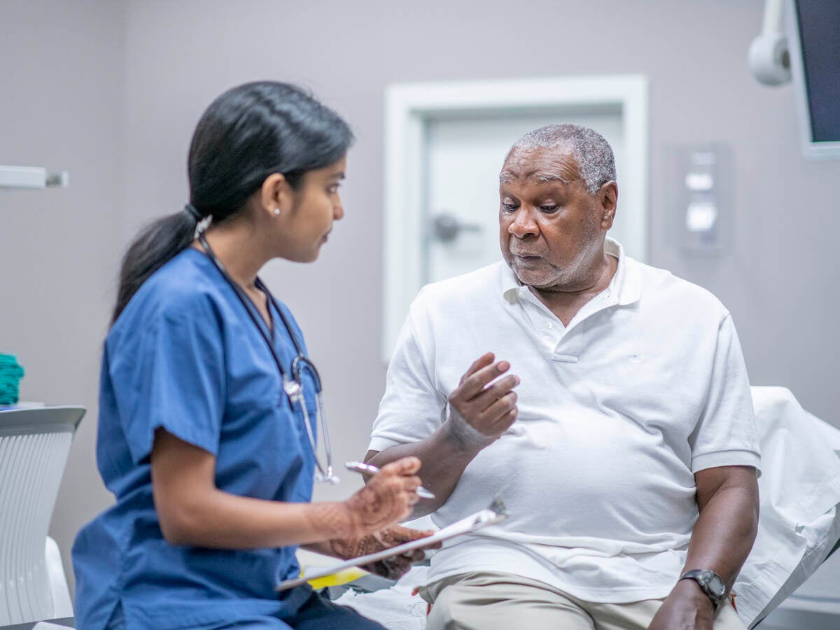 Nurse examining older patient