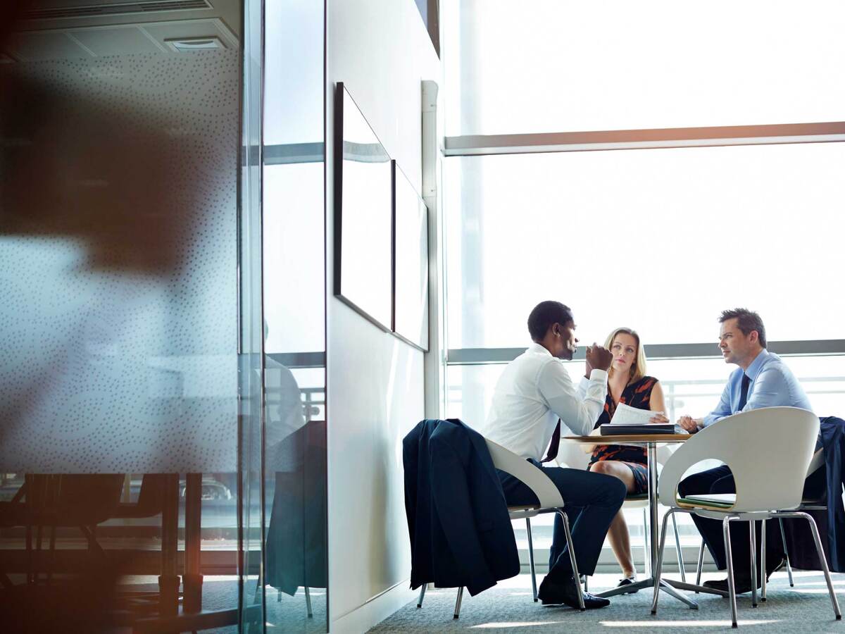 Three business people at a table having a meeting