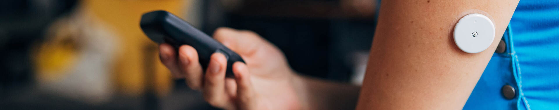 Person testing their blood sugar with wireless medical device